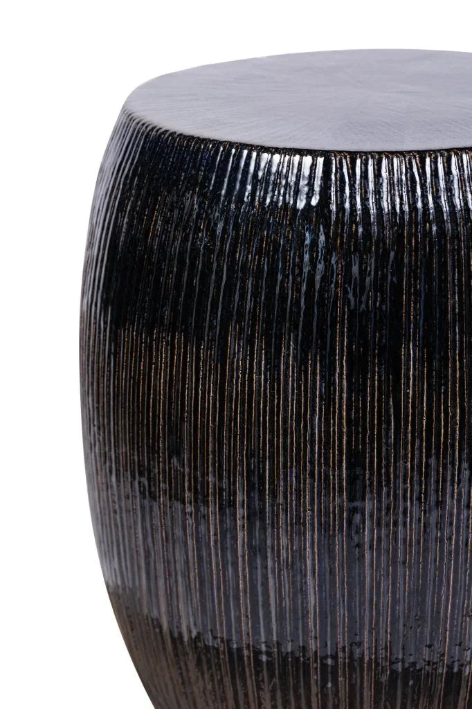 Decorative cylindrical stool with textured surface on a white background