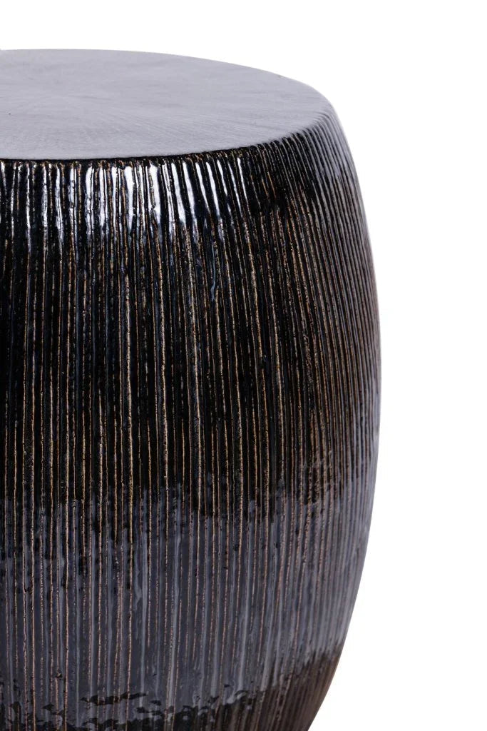 Close-up of a textured cylindrical stool with a white background