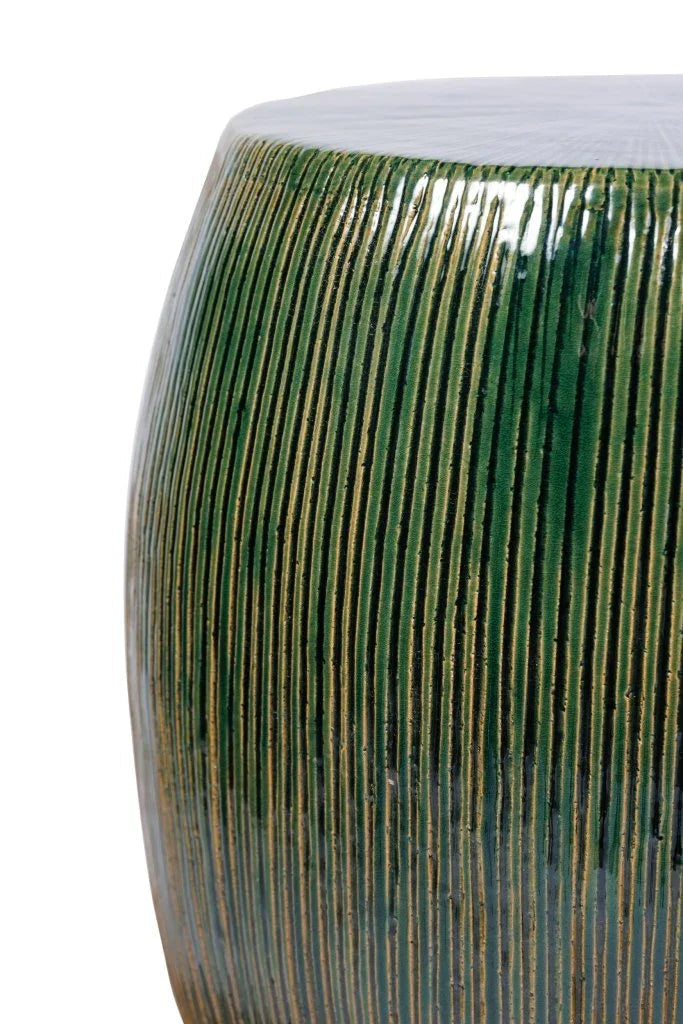 Cylindrical stool with vertical green ribbed design on a white background
