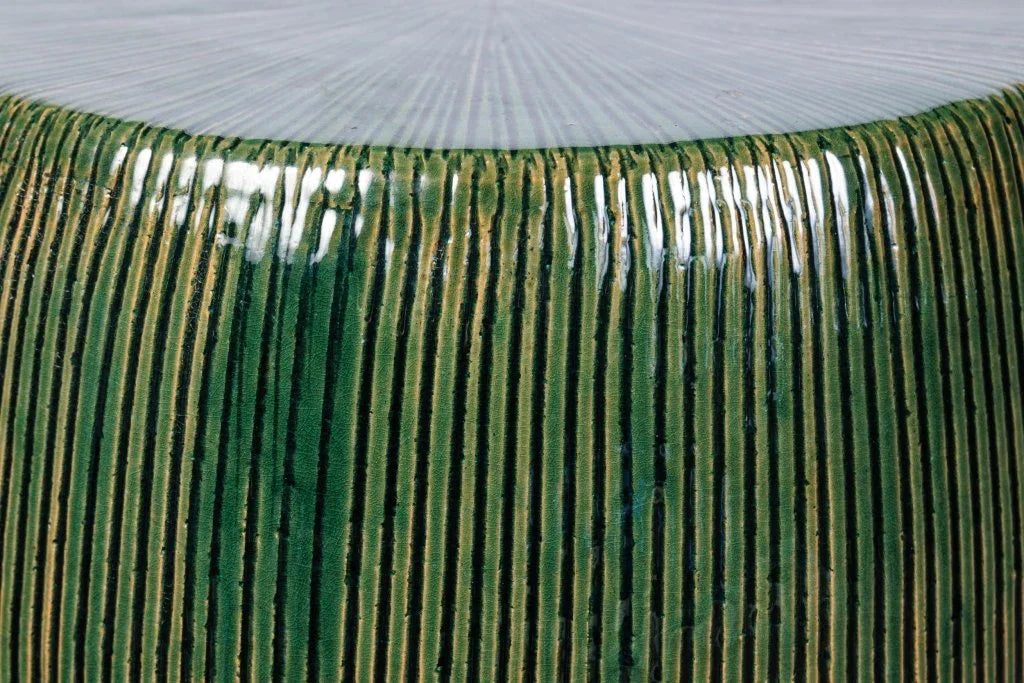 Close-up of a green stool with a circular pattern.