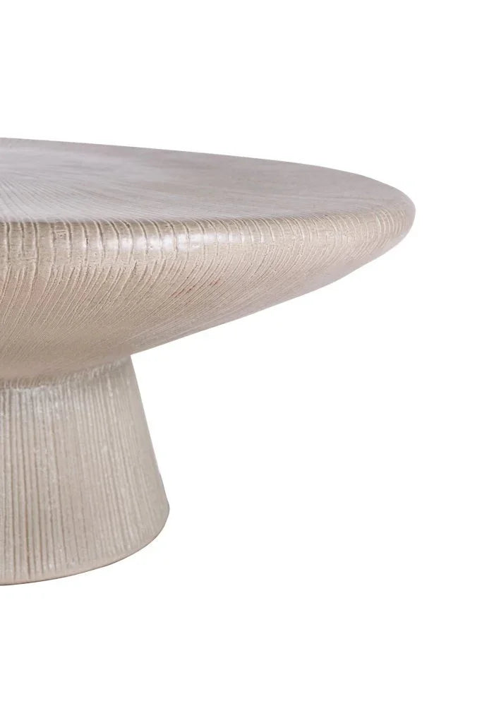 Round beige table with textured surface on a white background