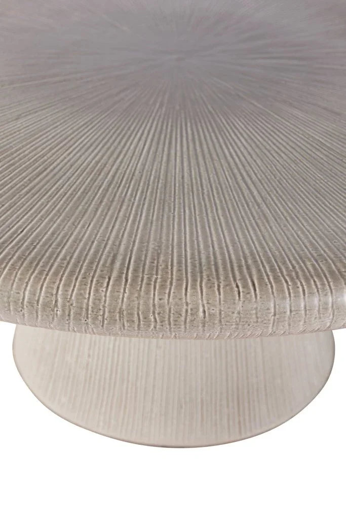Close-up of a textured round table with a ribbed surface.