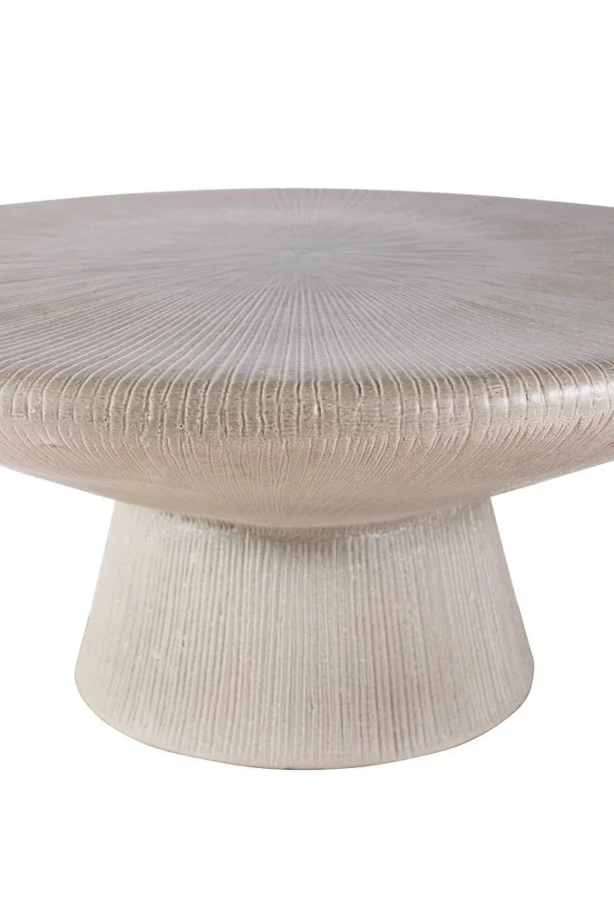 Round textured coffee table on a white background