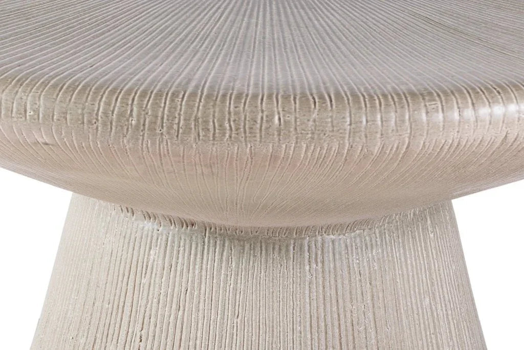 Close-up of a textured round table with a neutral color palette.