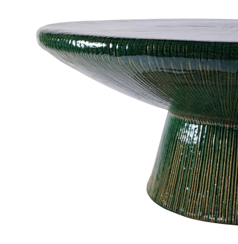 Green ceramic table with textured design on a white background