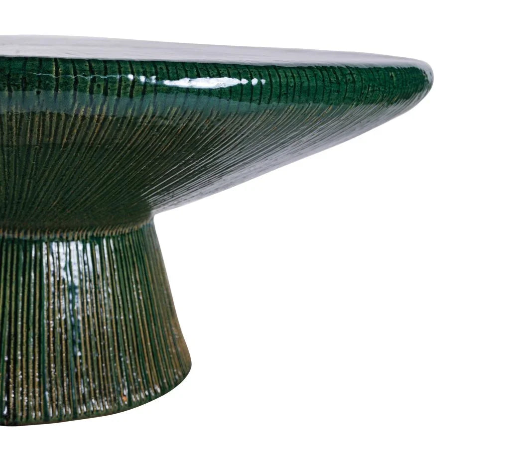 Green ceramic table with textured surface on a white background