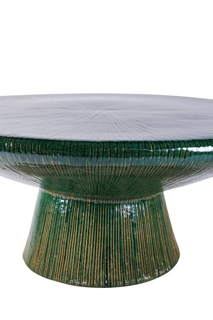 Green ceramic table with ribbed design on a white background