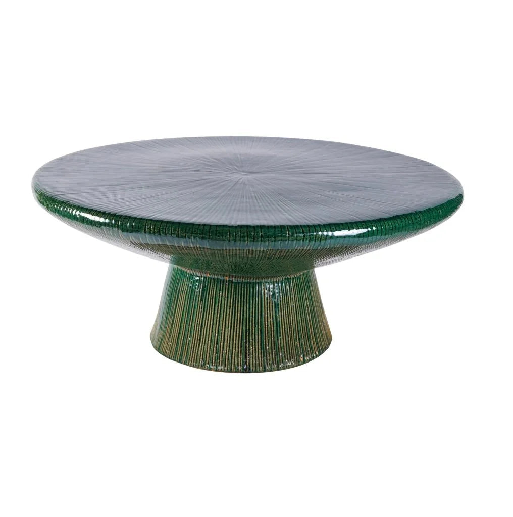 Round ceramic table with green base and green top on a white background