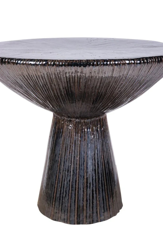 Decorative accent table with textured surface on a white background