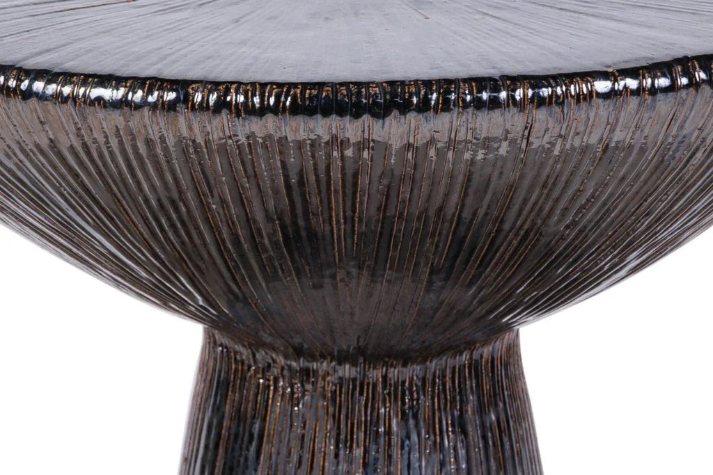 Close-up of a textured round table with metallic rim on a white background