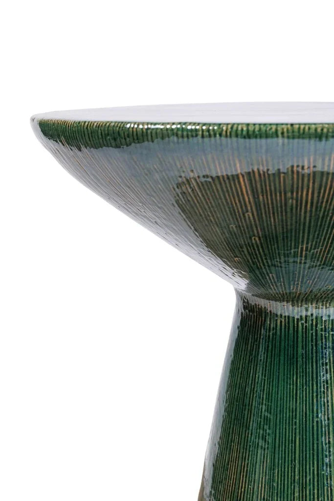 Green ceramic bowl with textured surface on a white background