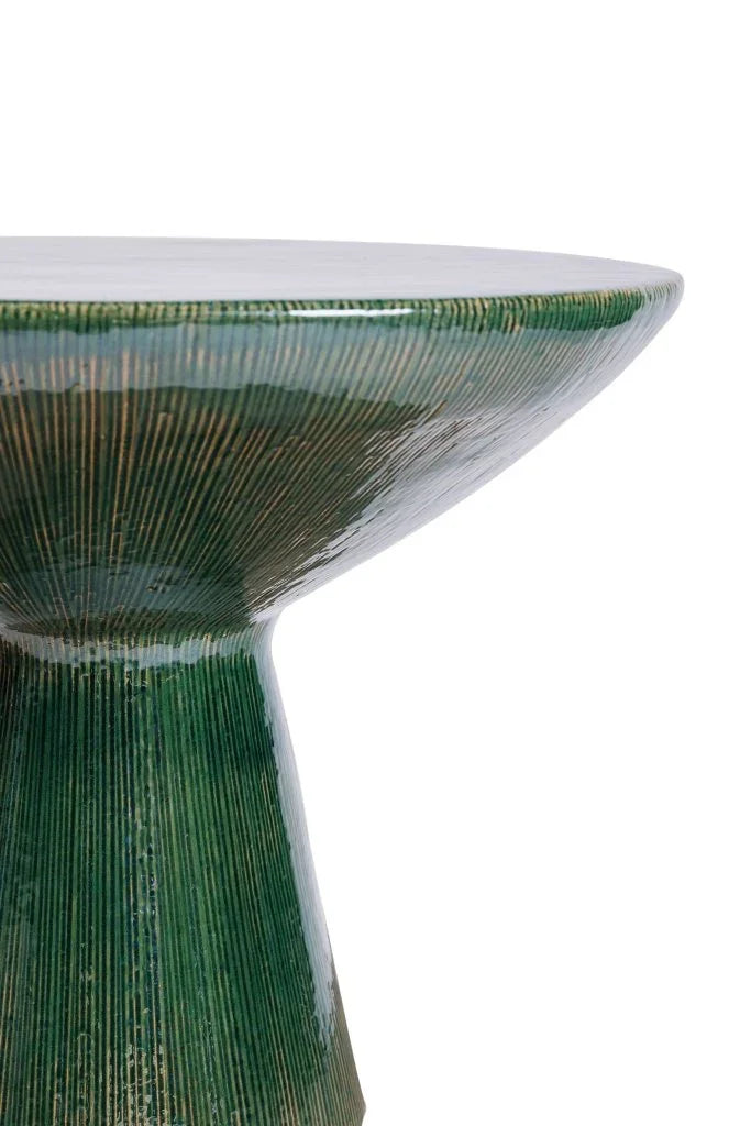 Close-up of a green and white ceramic bowl with a textured surface.
