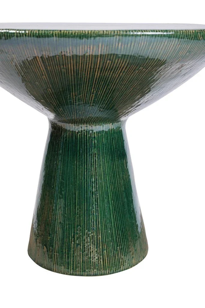 Green ceramic table with textured surface on a white background