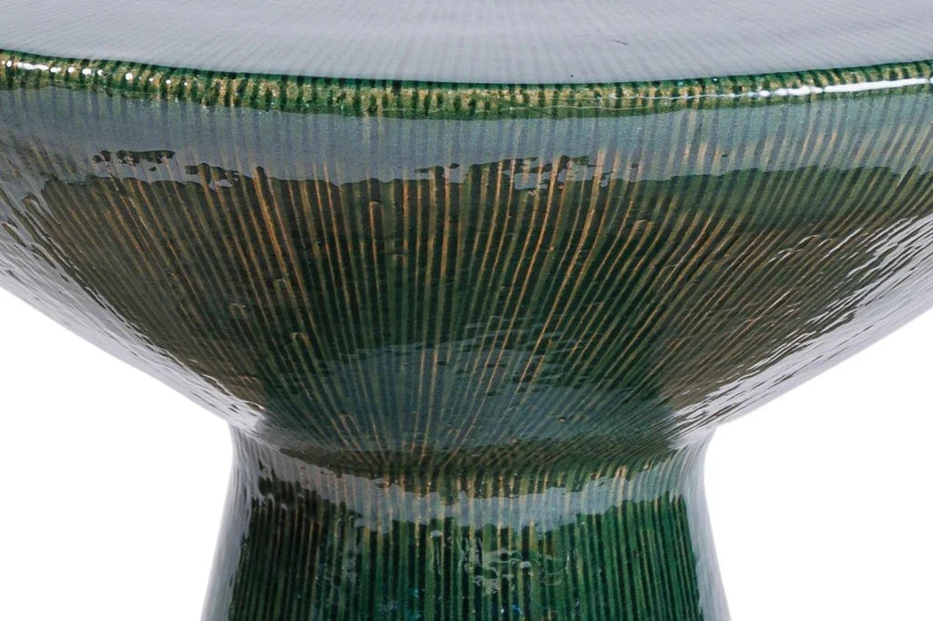 Close-up of a green ceramic table with a textured surface on a white background