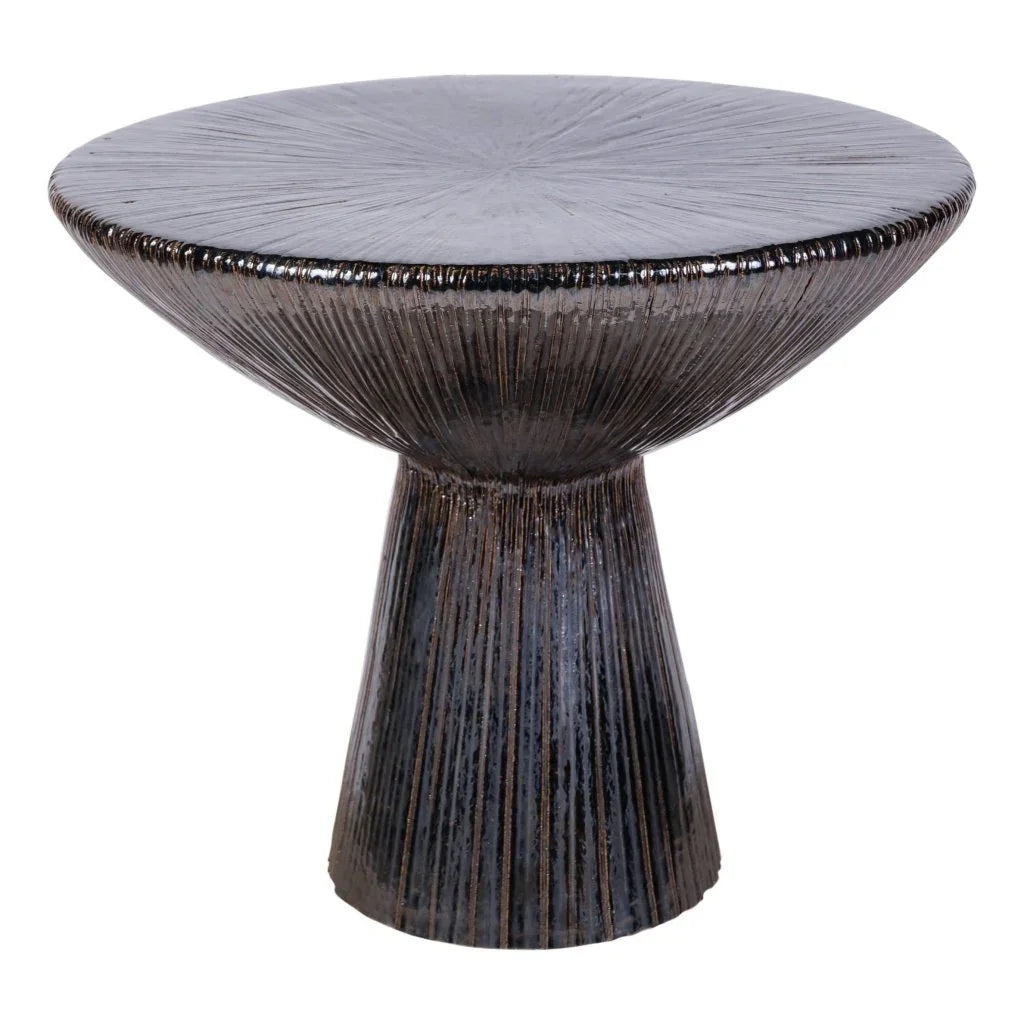 Round textured black table on a white background