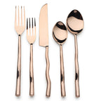 Rose gold cutlery set on a white background