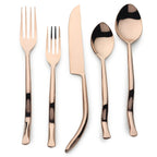 Set of rose gold cutlery including fork, knife, and spoons on a white background