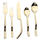 Set of gold cutlery including forks and knives on a white background