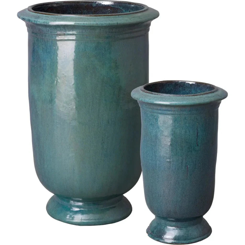Two blue ceramic planters of different sizes on a white background