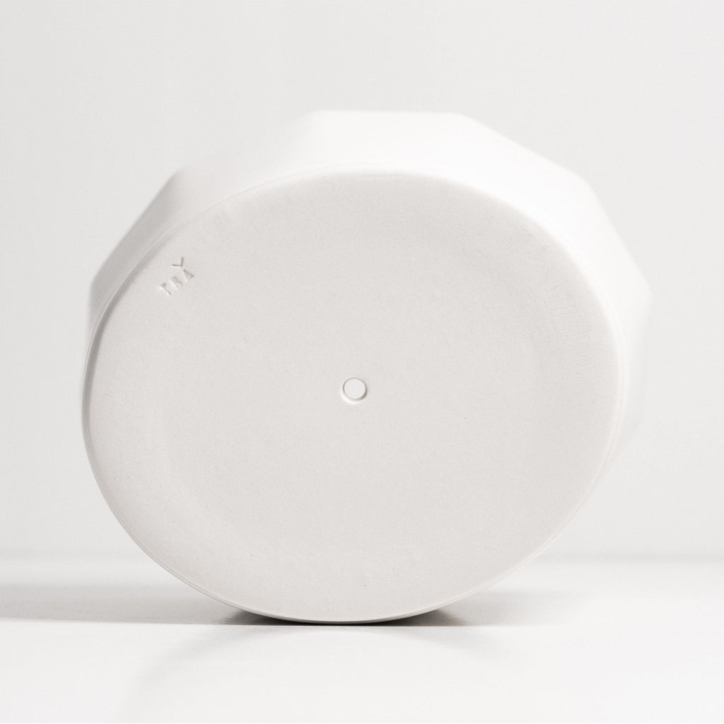 White round planter on a light gray background