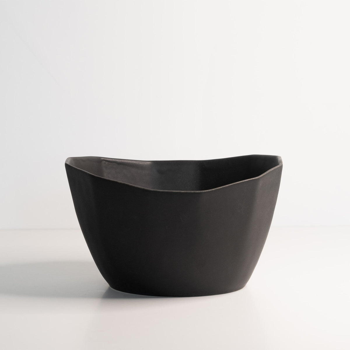Black ceramic bowl on a white background