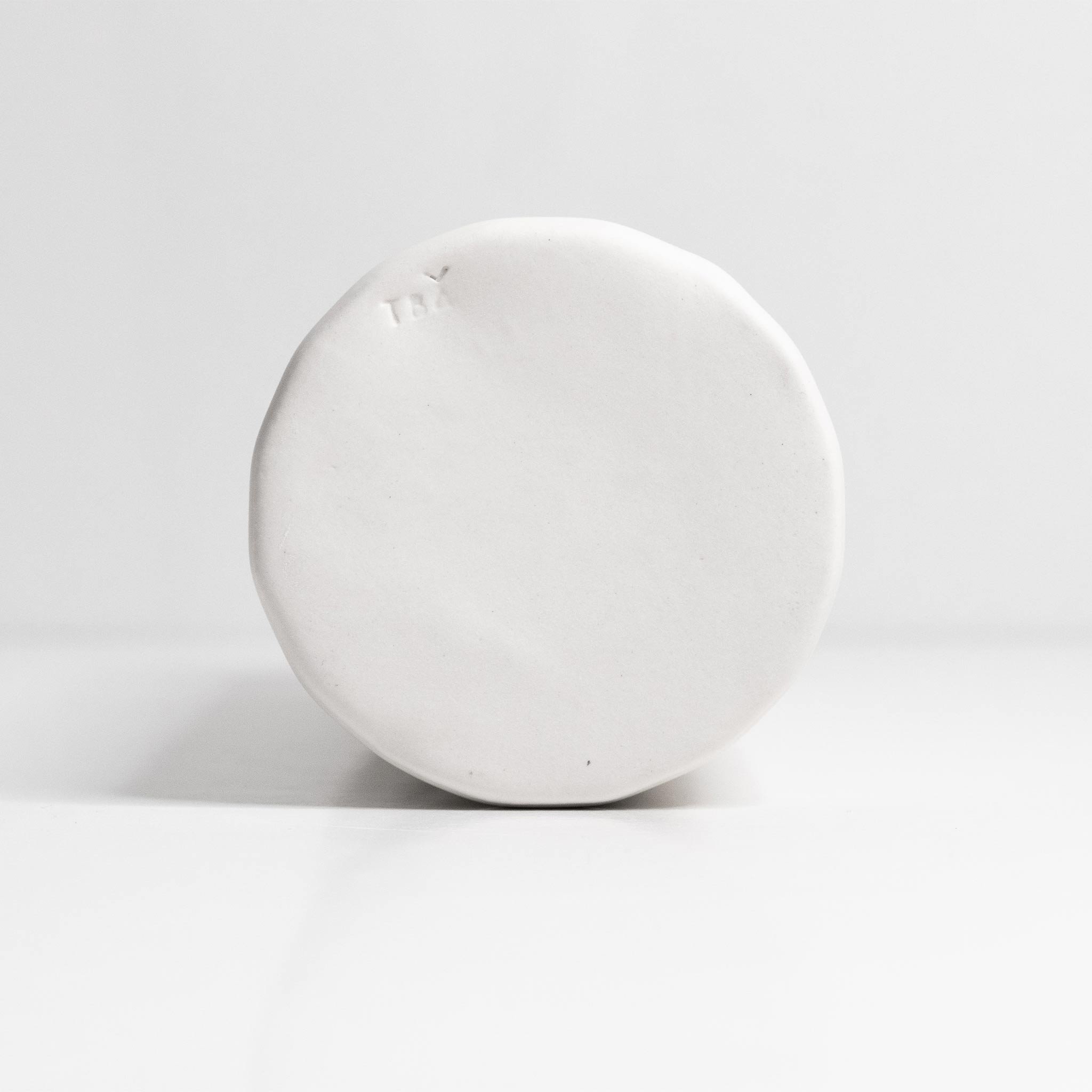 White spherical object on a light gray background