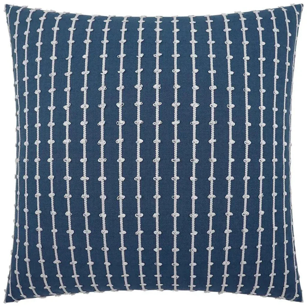 Blue pillow with white geometric pattern on a white background