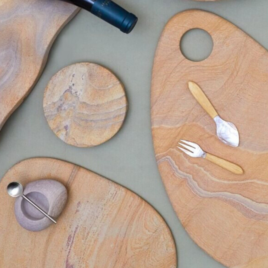 Wooden cutting boards with marble patterns on a light gray surface.