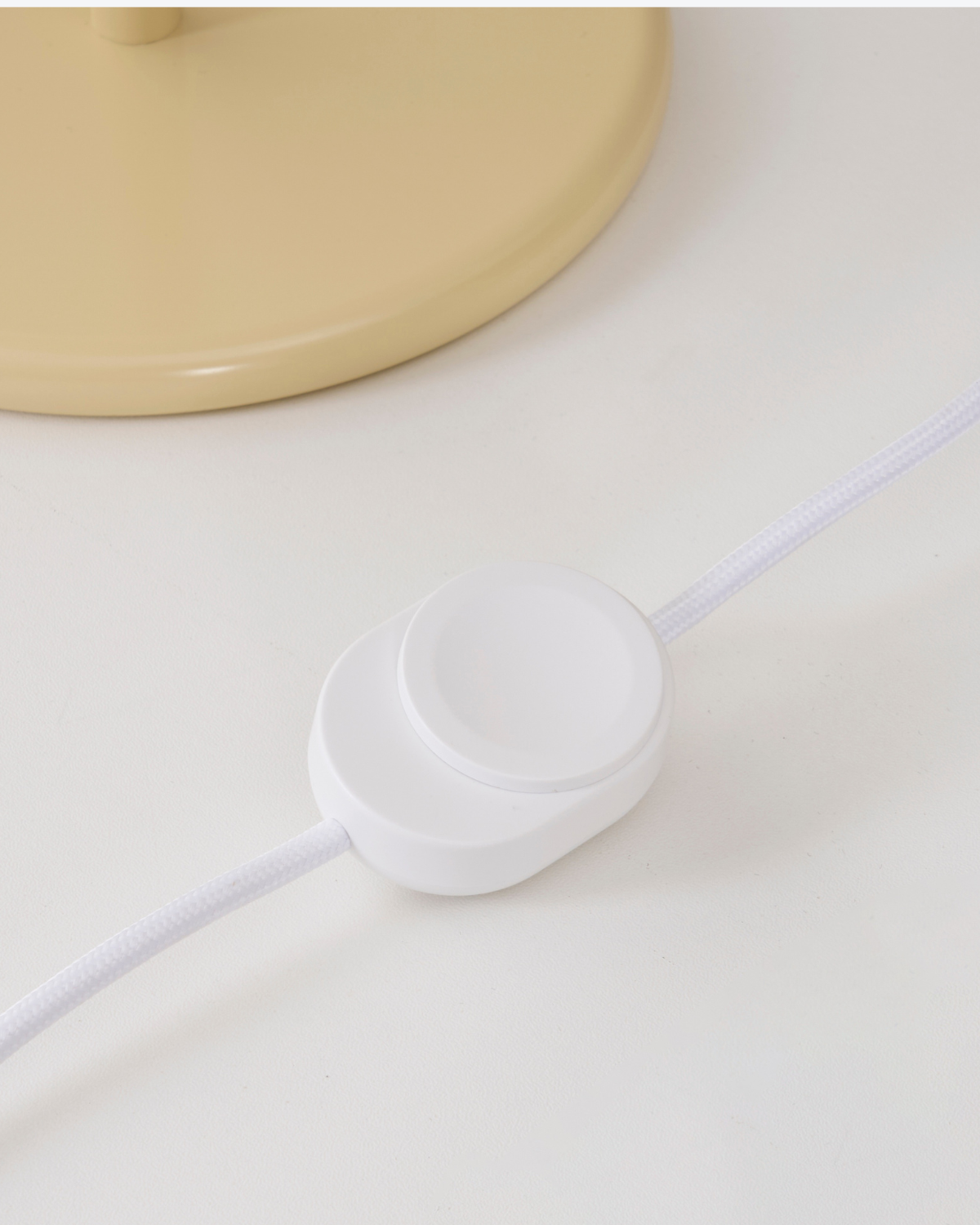 Close-up of a lamp cord switch on a light background
