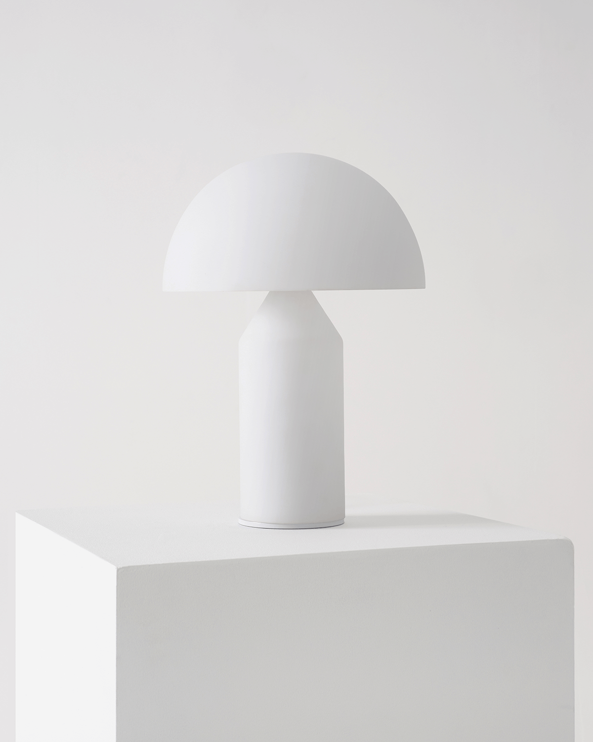 White table lamp on a white surface with a white background