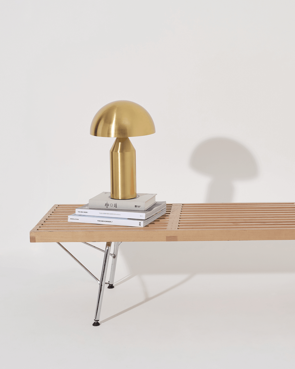 Gold lamp on a wooden table with a white background