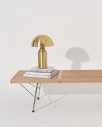 Gold lamp on a wooden table with a white background