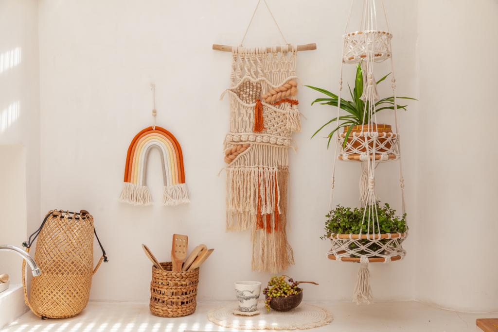 Hanging macrame wall art and plant holder on a white wall.