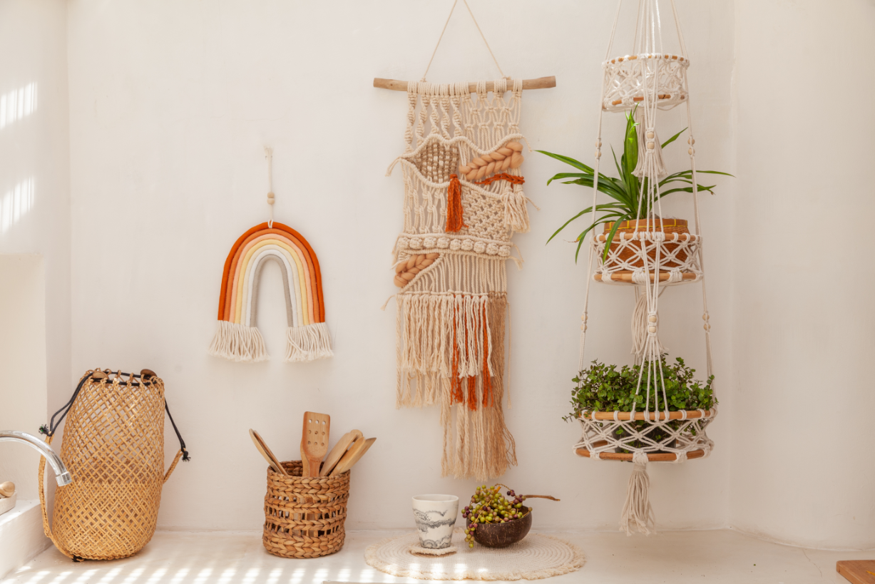 Hanging macrame wall art and plant holder on a white wall.