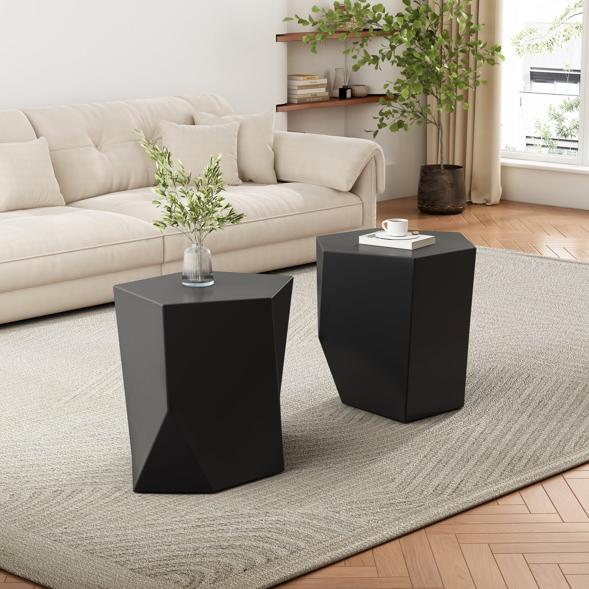 Two black geometric convertible side tables in a living room setting with a beige sofa and decorative items.