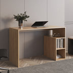 A light wood writing desk with an open main compartment and a smaller side cabinet shelf, shown in a styled home office setting with a laptop, vase, books, and a chair.