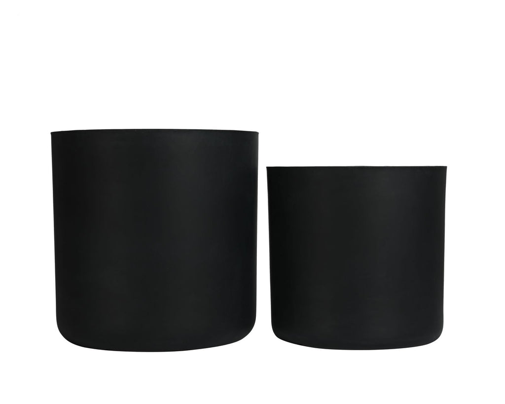 Two black cylindrical planters on a white background