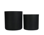 Two black cylindrical planters on a white background