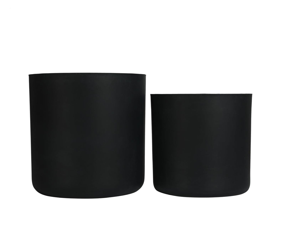 Two black cylindrical planters on a white background