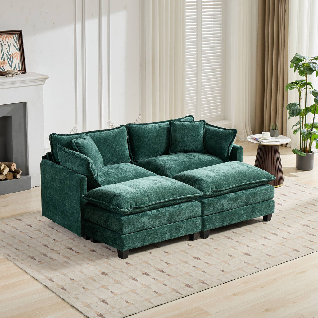 Green sofa in a living room setting with a fireplace and plants.