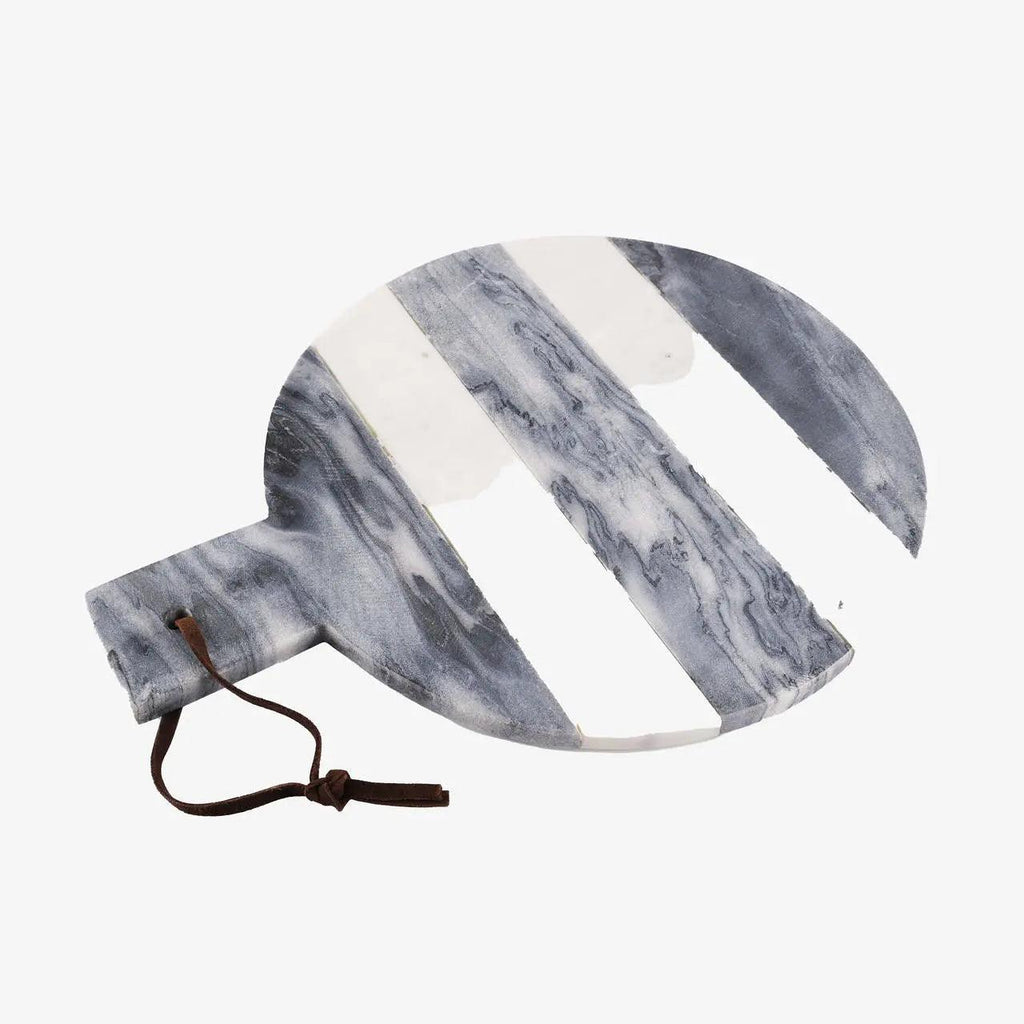 A round marble serving board with a handle and a dark brown leather drawstring, featuring diagonal white stripes over a blue-gray and white marble pattern, on a solid white background.