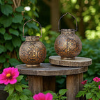 Two ornate lanterns on a wooden stand with flowers in the foreground