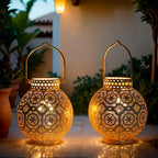 Two ornate lanterns with intricate designs on a patio setting.