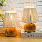 Two wooden table lamps with woven shades on a textured wall background.