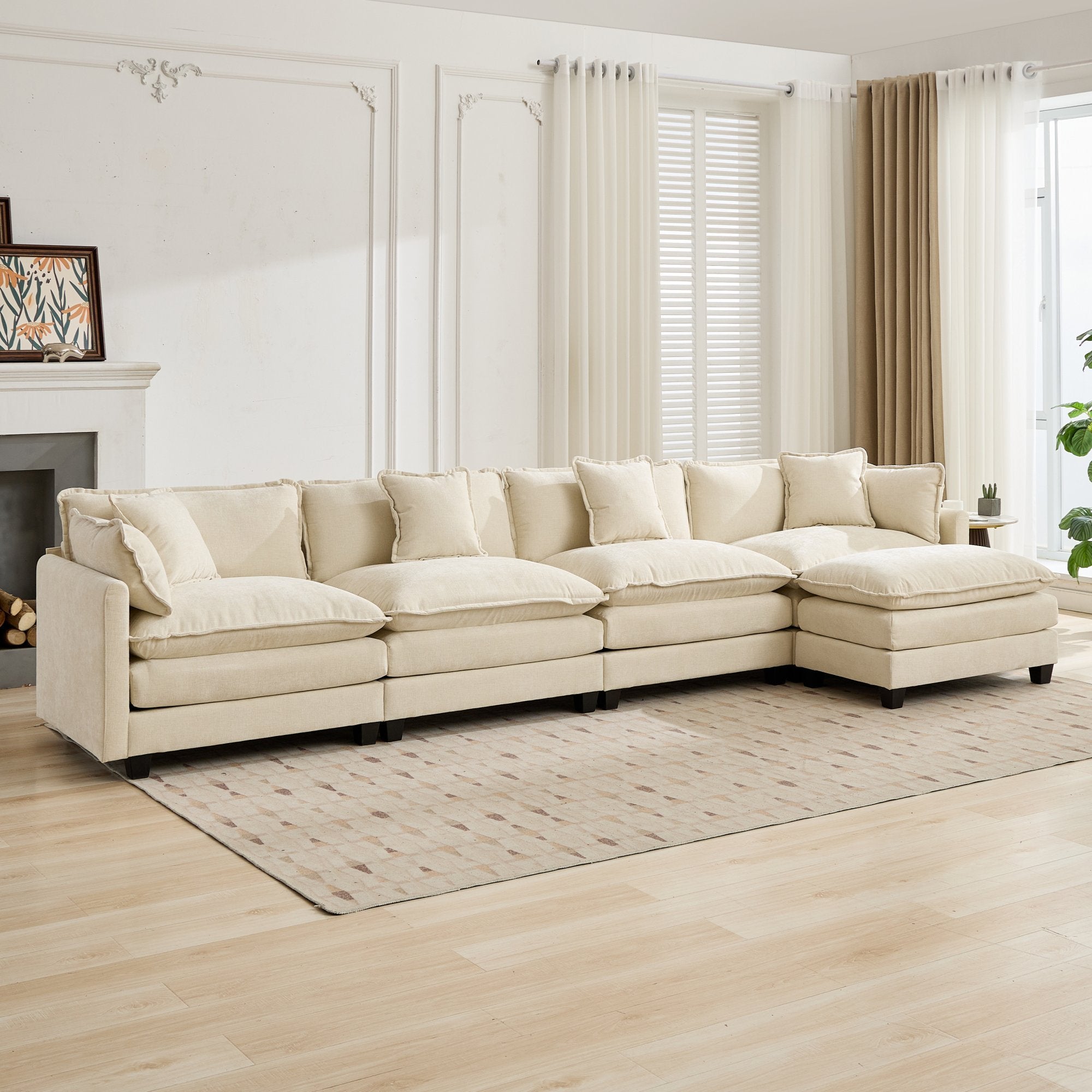 Beige sectional sofa in a living room with light wood flooring and large windows.