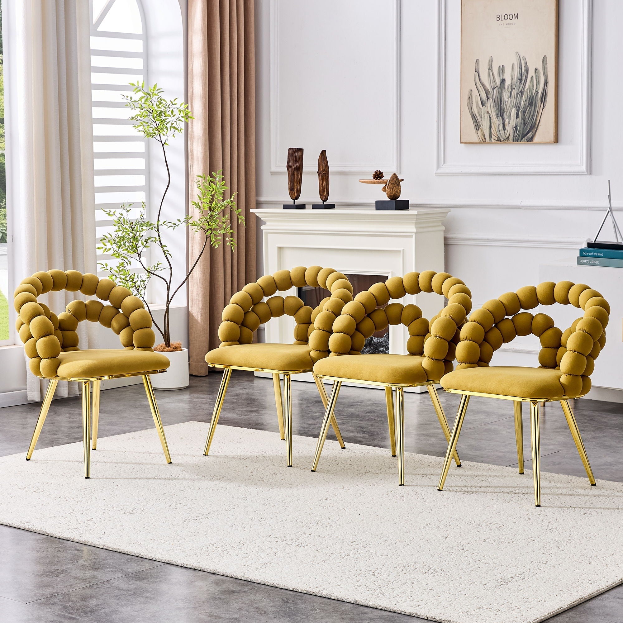 Four yellow chairs with gold legs arranged in a circle in a stylish living room.