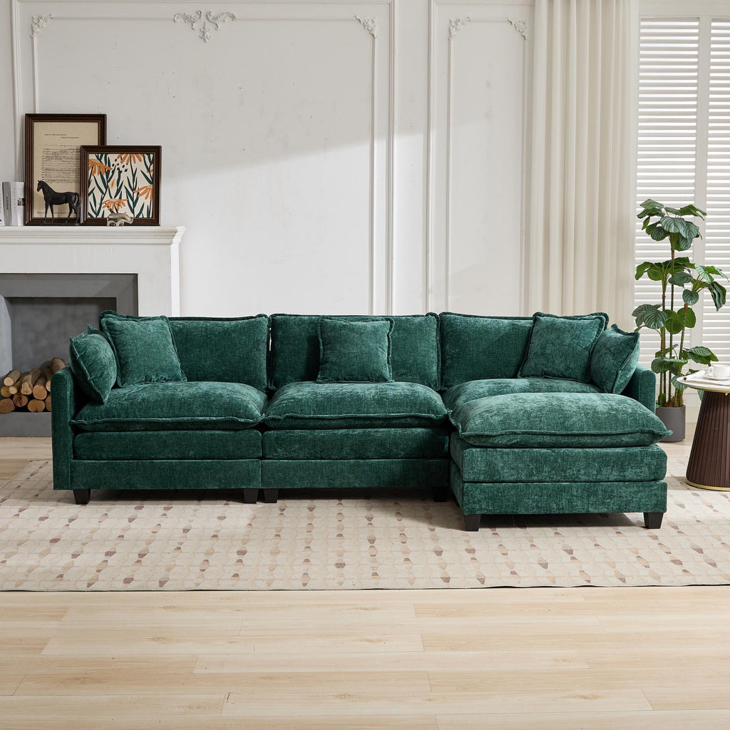 Green sectional sofa in a living room setting with a fireplace and decor.