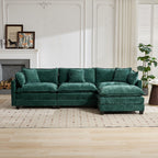 Green sectional sofa in a living room setting with a fireplace and decor.
