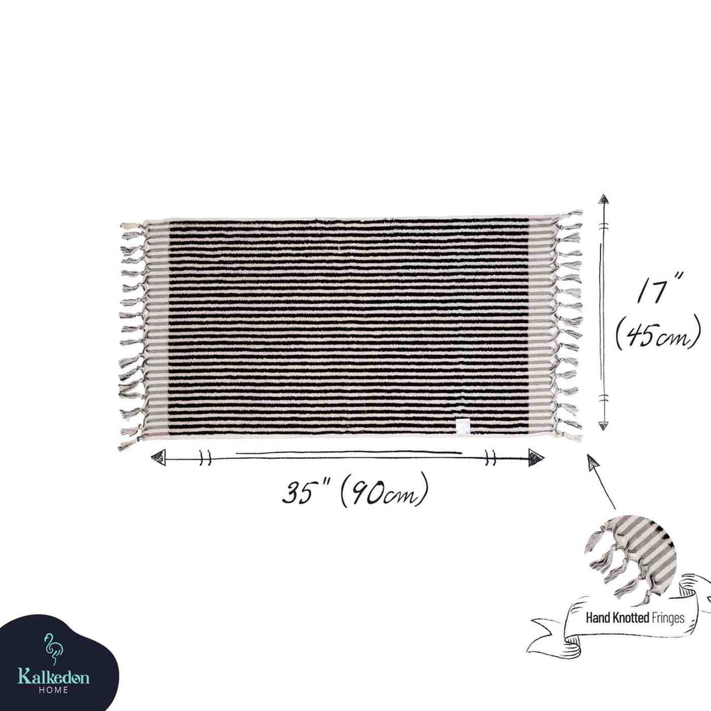 Black striped hand towel with hand-knotted fringes, measuring 35 x 17 inches.