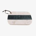 Marble cutting board with a green stripe and brown handle on a white background